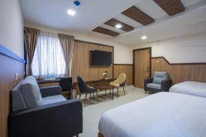 Postel nebo postele na pokoji v ubytování Hotel PRM Aruna Archadia