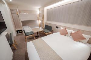 a hotel room with a bed and a desk and a chair at RESI STAY Kuon in Kyoto