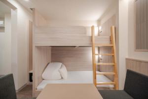 a small room with a bunk bed and a ladder at RESI STAY Kuon in Kyoto