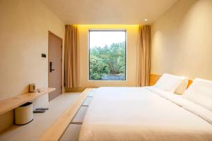 Postel nebo postele na pokoji v ubytování Shanghai Xingshe Camping B&B Disney Branch