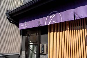 a building with a purple sign above a door at RESI STAY Kuon in Kyoto +63 photos