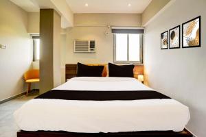Postel nebo postele na pokoji v ubytování Vibes Inn Juhu