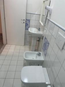 a bathroom with a toilet and a sink at casa catania termini home 3 in Catania