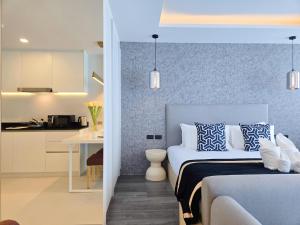 a bedroom with a bed with blue and white pillows at Karon Utopia in Ban Karon +27 photos