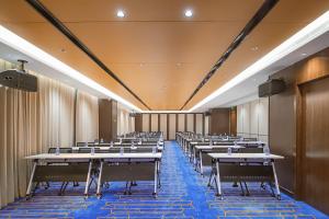 a room with rows of tables and chairs at Metropolo, Shaoxing, Wanda Plaza-Keqiao in Shaoxing