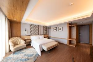 Postel nebo postele na pokoji v ubytování Myze Hotel Sumenep