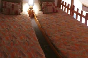 a bedroom with a large bed with a lamp on it at Appartement chaleureux à Gresse-en-Vercors 43 m² vue montagne in Gresse-en-Vercors +6 photos