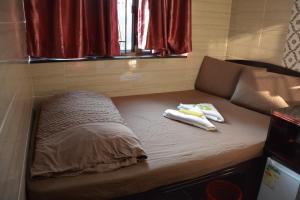 Un pat sau paturi într-o cameră la Everest Hostel