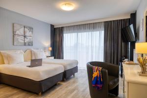 Postel nebo postele na pokoji v ubytování First Euroflat Hotel