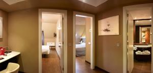 a hotel room with a bathroom and a bedroom at Silken Monumental Naranco in Oviedo
