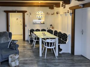 a dining room with a white table and chairs at Ferienwohnung Alpenglück mit Schwimmbad und Sauna in Oberstdorf