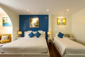 Postel nebo postele na pokoji v ubytování Chez Mimosa Corner