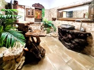 a bathroom with a sink and a wooden table at Villa Paraiso - Naturism Optional Adults Only in Porches