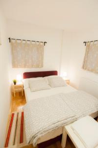 a bedroom with two beds and a window at Fifty Apartments in Zagreb