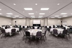 a conference room with tables and chairs and a screen at Wyndham Garden Fort Walton Beach Destin in Fort Walton Beach +68 photos