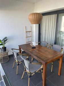 a wooden table and chairs in a dining room at Las Dunas Blancas - Roof Top - by FTV Holidays Homes in Villaverde