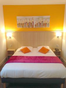 a bedroom with a bed with two pillows and shelves of bottles at Hôtel Restaurant L'Evidence in Neufchâteau