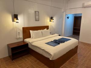 a bedroom with a bed with a towel on it at Bolabog Beach Resort in Boracay +28 photos