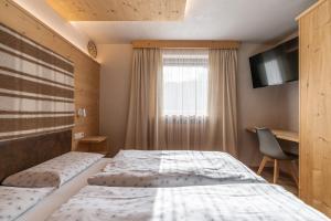 Posteľ alebo postele v izbe v ubytovaní Ciasa Iachin - Dolomites Dream Retreat