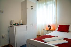a bedroom with a white bed and a red pillow at Guest House Cesic in Dubrovnik +13 photos