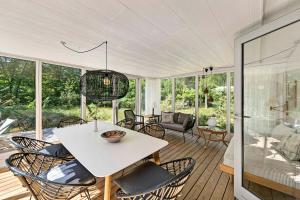 a living room with a white table and chairs at Cottage In Peaceful Surroundings In Vester Sømark in Vester Sømarken
