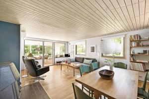 a living room with a table and a couch at Cottage In Peaceful Surroundings In Vester Sømark in Vester Sømarken