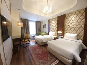 Voodi või voodid majutusasutuse Sarovar Premiere Srinagar toas