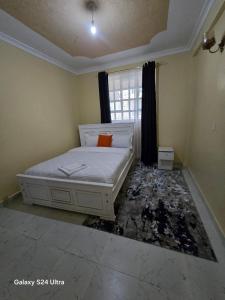 a bedroom with a bed and a smashed floor at The comfort 2 bedrooms pioneer in Eldoret