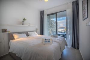 a bedroom with a bed with a new desk sign on it at Lighthouse Family Apartment with Private Pool in Kyrenia