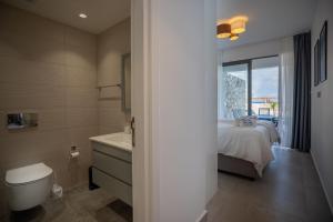 a bathroom with a bed and a tub and a sink at Lighthouse Family Apartment with Private Pool in Kyrenia