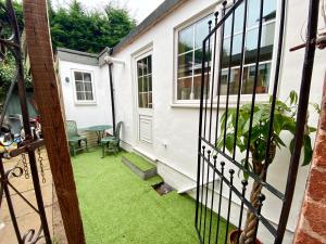 a view from the front door of a house with green grass at Bumblebee Cottage in Knowle