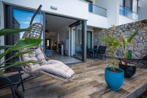 a porch with a swinging chair and some plants at Lighthouse Family Apartment with Private Pool in Kyrenia