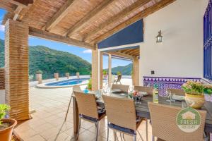 an external view of a villa with a table and chairs at Casa de la Luz - lovely family villa in Arenas