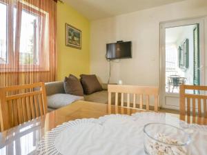 a living room with a table and a couch at Apartments Angelina - 2min to the beach in Karlobag