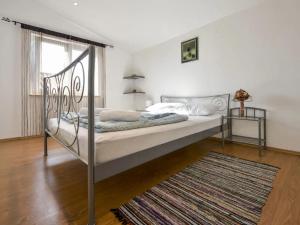 a bed with a metal frame in a bedroom at Apartments Angelina - 2min to the beach in Karlobag