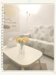a living room with a table and a couch at Yong Yong House in Seoul