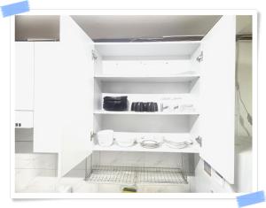 a kitchen with white shelves with dishes on them at Yong Yong House in Seoul