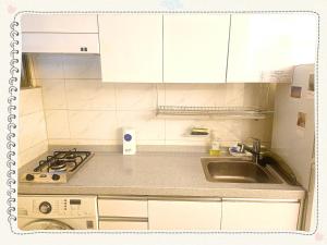 a small kitchen with a sink and a stove at Yong Yong House in Seoul +2 photos