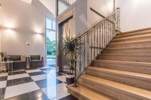 a lobby with stairs and a potted plant at Vila Komoda in Palanga