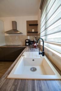 a white sink in a kitchen with a window at Holiday Home Peaceful Oasis with Pool in Drvenik