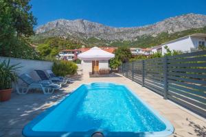 a swimming pool with a view of a mountain at Holiday Home Peaceful Oasis with Pool in Drvenik
