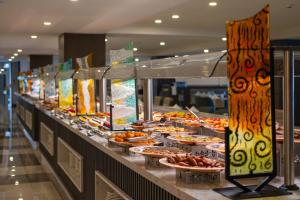 a buffet line with plates of food on display at The X Belek in Belek