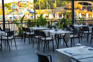 a restaurant with tables and chairs and a ride at The X Belek in Belek