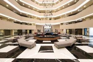 a lobby of a hotel with couches and a table at The X Belek in Belek