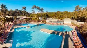eine Draufsicht auf einen Swimmingpool in einem Resort in der Unterkunft Le Nid des Viviers - Bungalow au bord de l'eau in Lège-Cap-Ferret + 14 Fotos