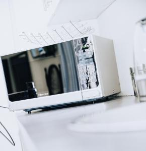 a microwave oven sitting on top of a counter at Ehrlichpark Lodge self catering and spa in Bloemfontein