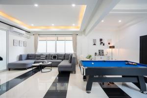 a living room with a pool table in it at White Chocolate Pool Villa Pattaya in Ban Huai Yai
