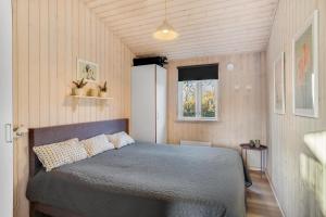 a bedroom with a bed in a small room at Beautiful Holiday Home With A Lovely View Of The Fjord And The Sea in Vestervig