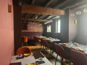 a dining room with long tables and chairs at Yak & Yeti in Shrewsbury