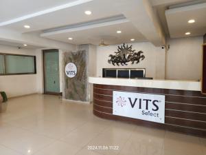 a hotel lobby with a vts select sign on the wall at VITS Select Bharuch in Bharūch